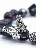 Handcrafted black acrylic bead bracelet with silver butterfly charm and Cubic Zirconia accents on a white background.