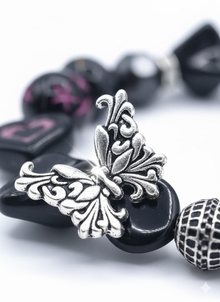 Handcrafted black acrylic bead bracelet with silver butterfly charm and Cubic Zirconia accents on a white background.